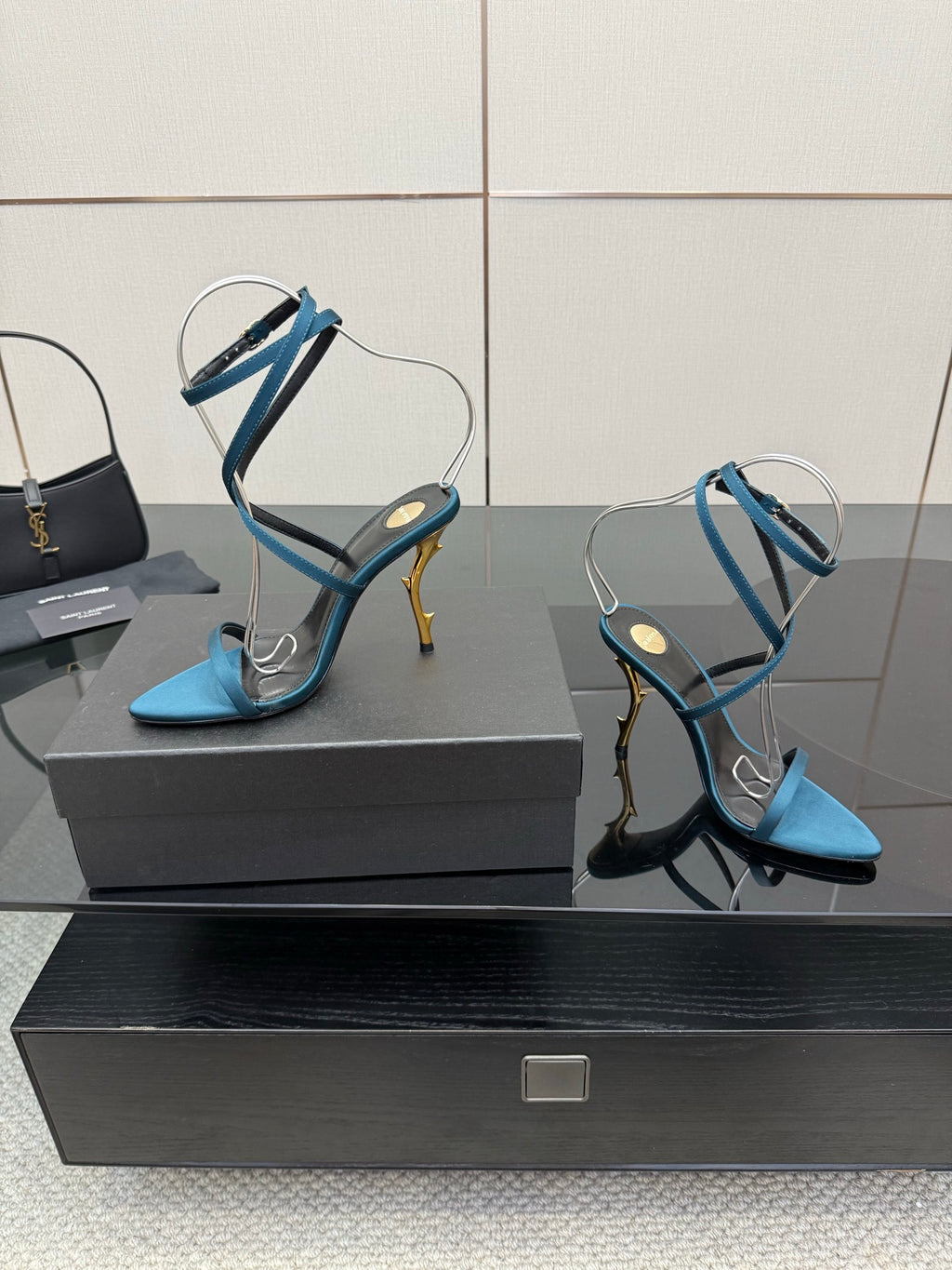 Pair of blue strappy high-heel sandals with thin ankle straps and pointed toes