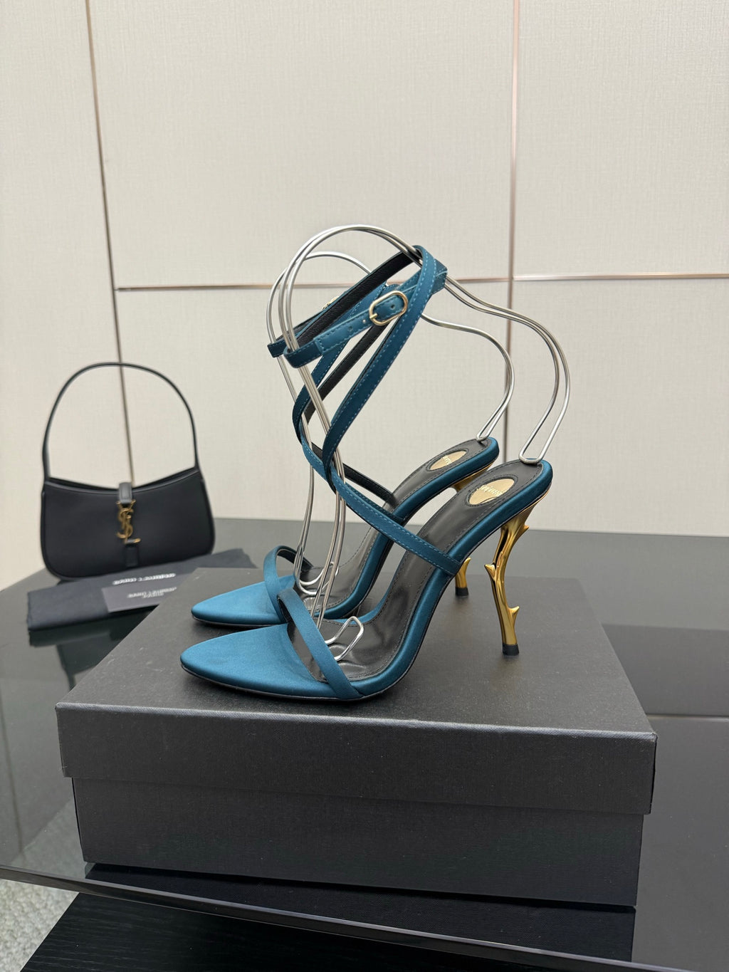 Blue strappy heeled sandals with ankle wrap and gold stiletto heel