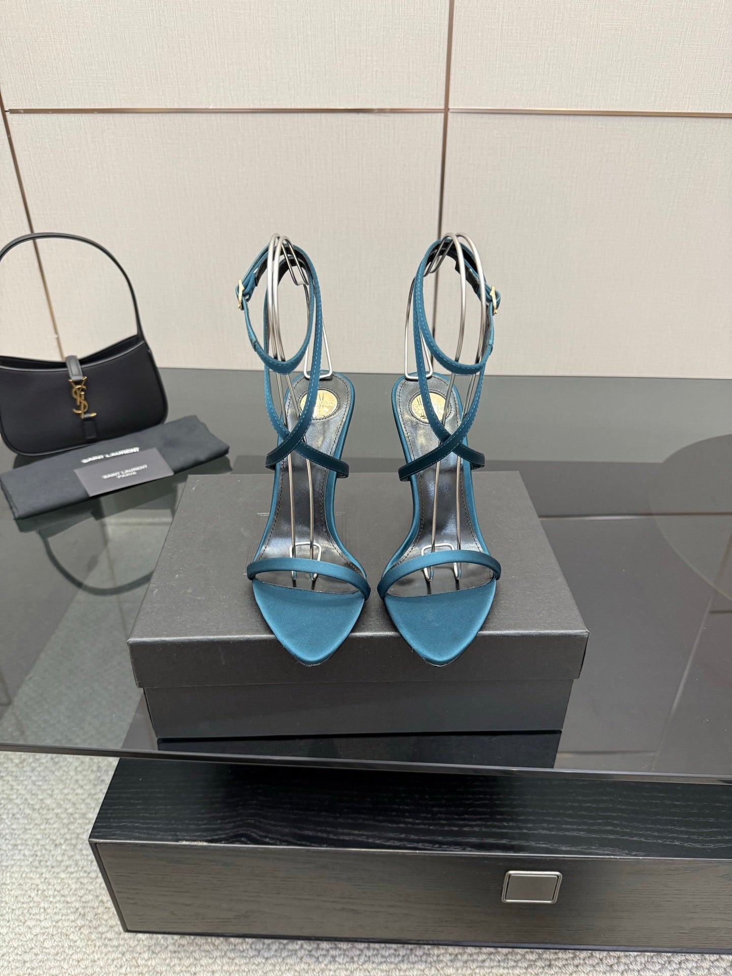 Blue heeled sandals in front view with clear straps and open toe