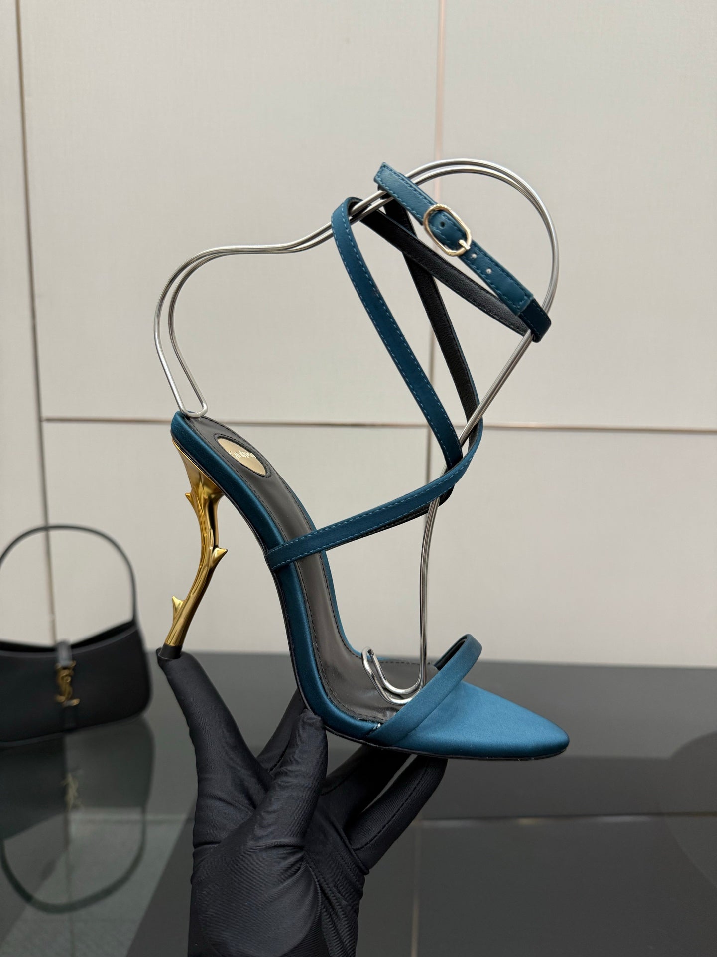 Blue strappy high-heel sandal with ankle strap and slender gold heel