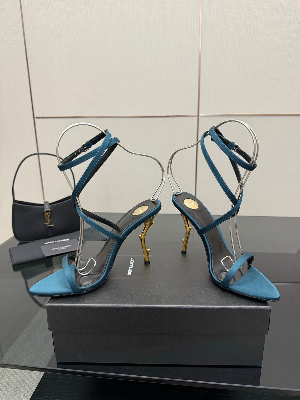 Blue strappy high-heel sandals with thin cross straps and pointed open toe