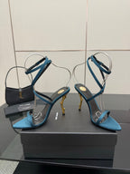 Blue strappy high-heel sandals with thin cross straps and pointed open toe