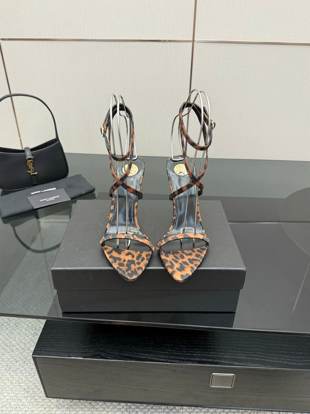 YSL women’s leopard-print heeled sandals with black T-strap and gold-tone stiletto heels