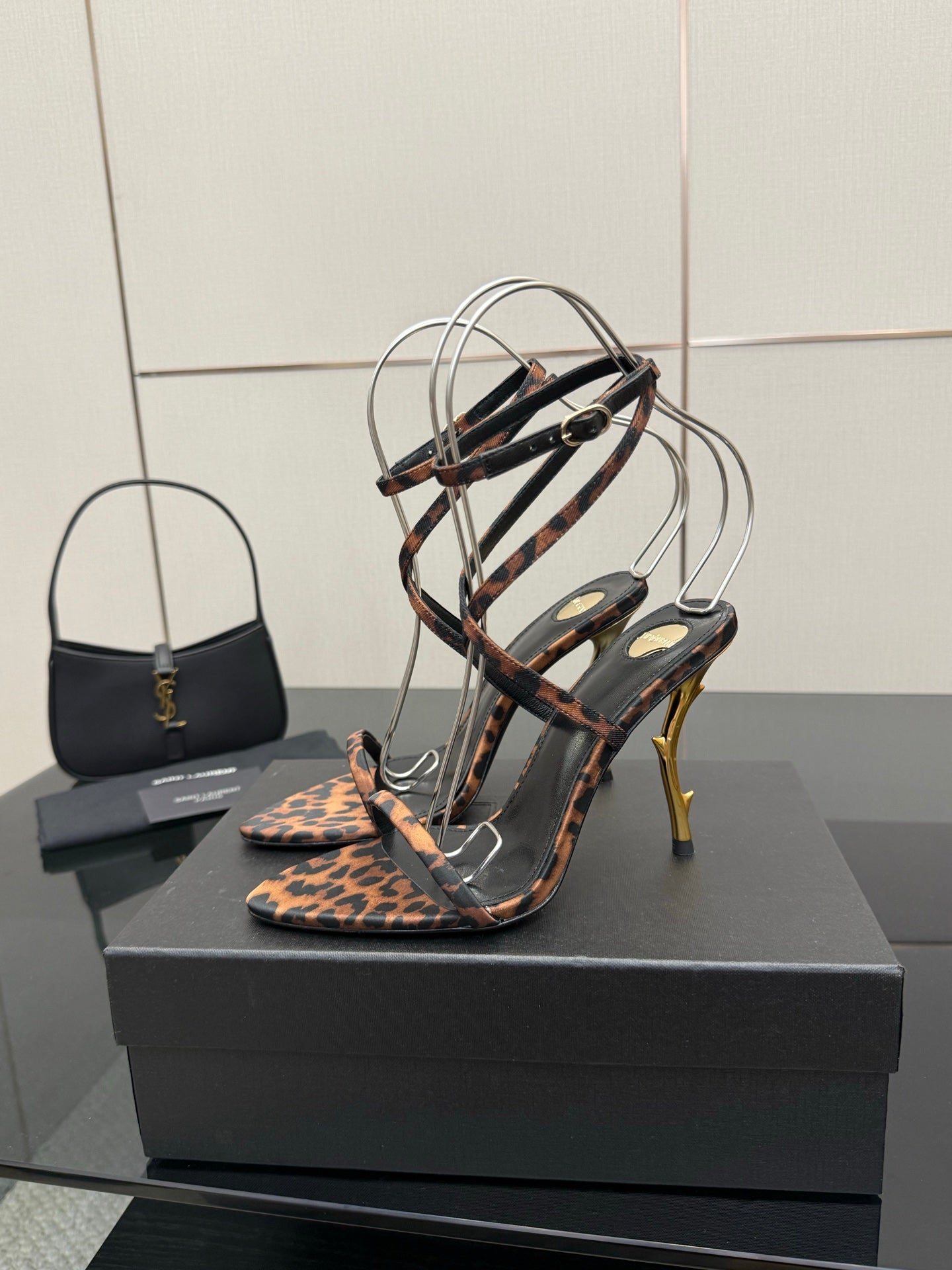 YSL women’s leopard-print heeled sandal with black T-strap and gold-tone stiletto heel