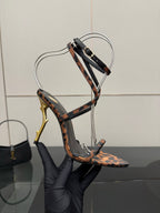 YSL women’s leopard-print sandal with black T-strap and gold-tone stiletto heel, close-up