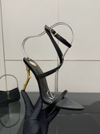 Black strappy heeled sandal with ankle wrap and gold-tone stiletto heel