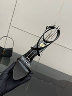 Black strappy heeled sandal with ankle straps and thin cross-strap design