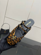 Prada leopard-print flats with ankle strap, showing interior lining and sole