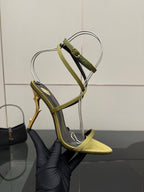 Designer high-heel sandal close-up, yellow toe with green ankle strap and gold heel