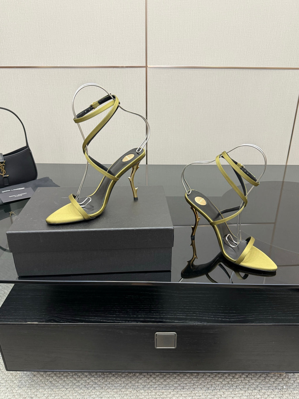 Designer high-heel sandals, pair shown: yellow toe with green strappy uppers