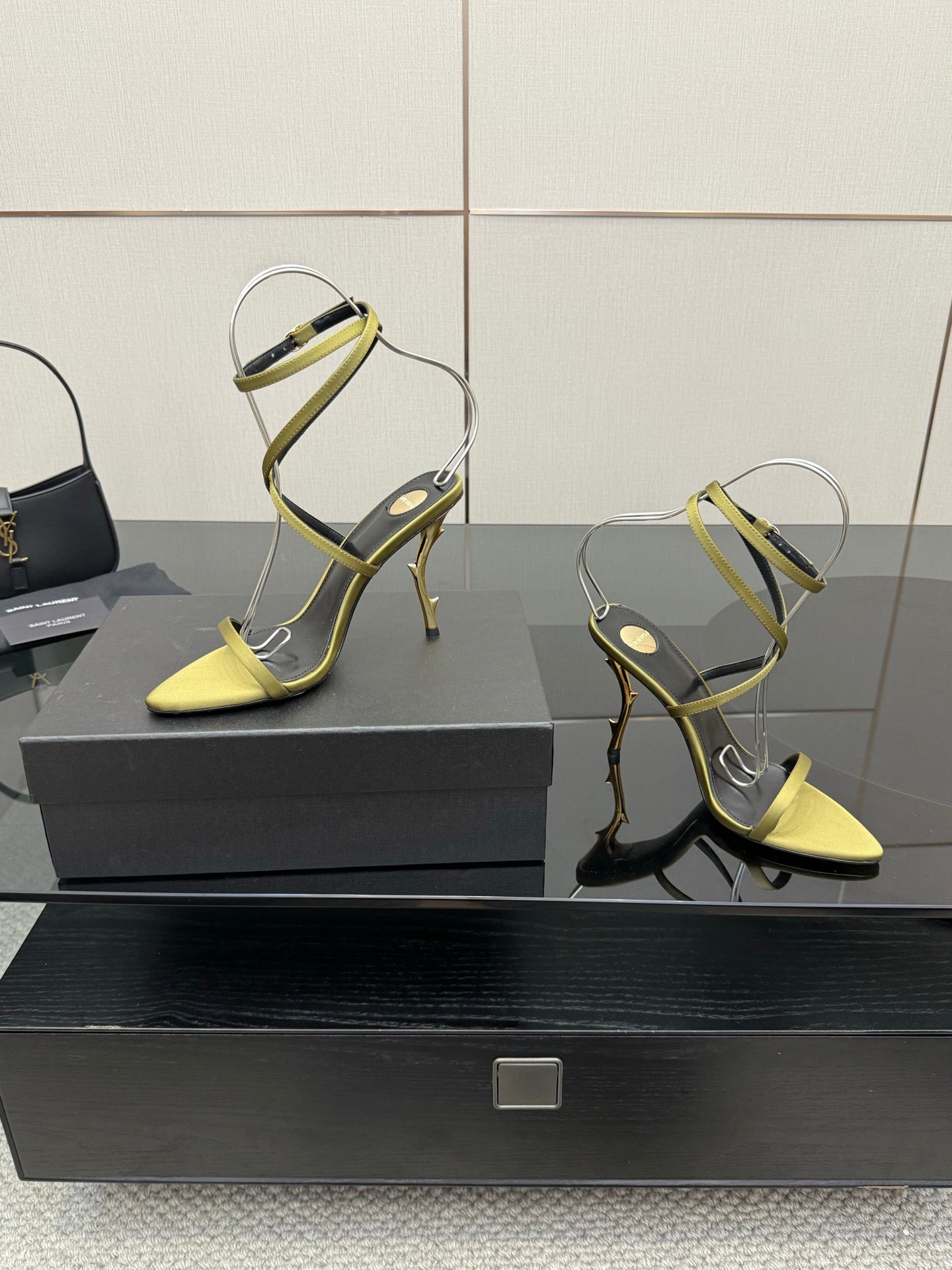 Designer high-heel sandals, pair shown: yellow toe with green strappy uppers
