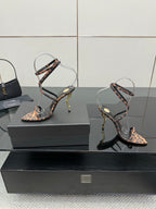 YSL women’s leopard-print heeled sandals with black straps and gold-tone stiletto heels, side view