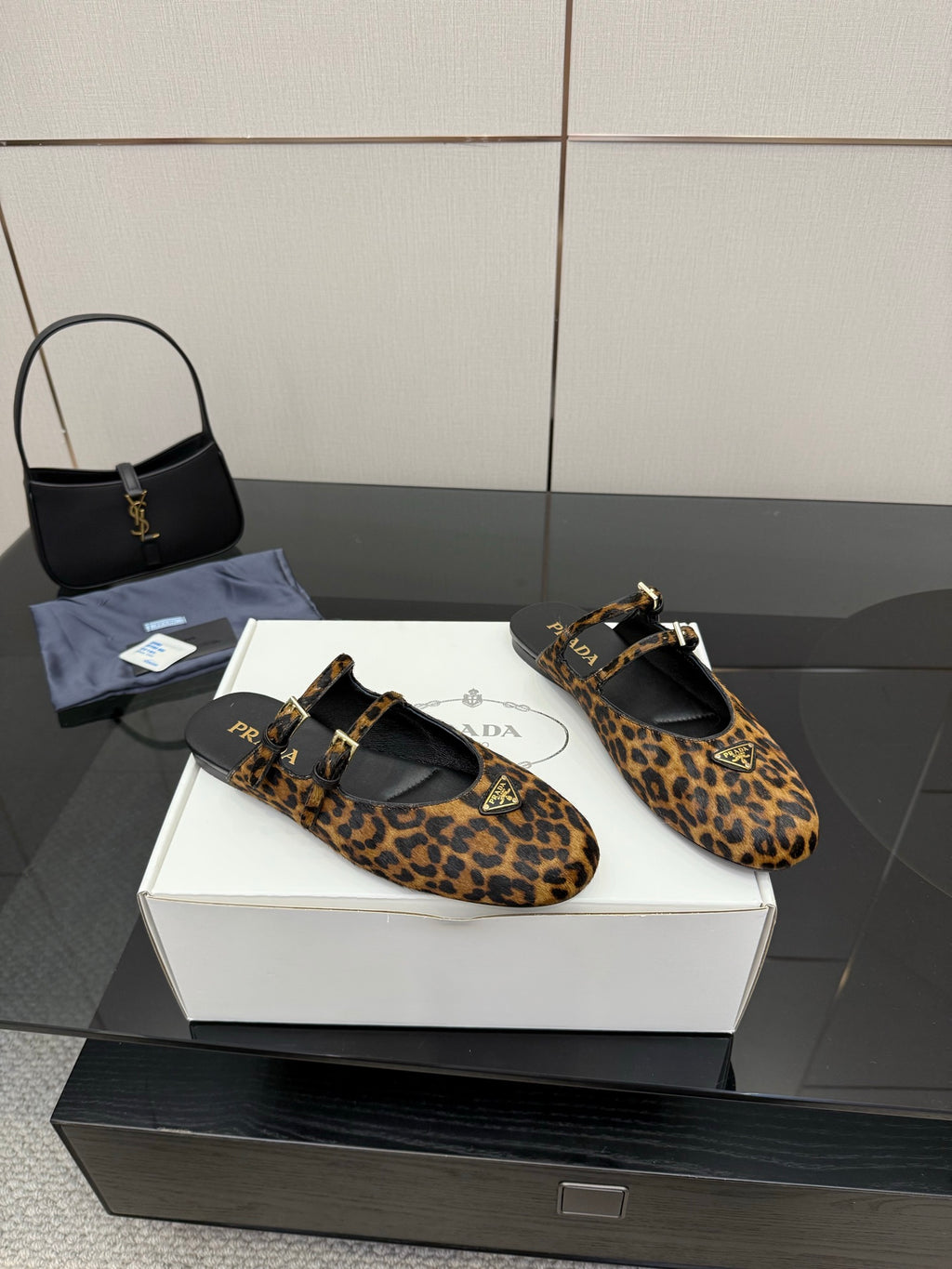 Prada leopard-print flats with black sole, ankle strap, and gold hardware