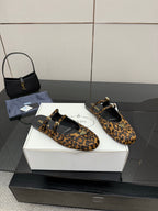 Prada leopard-print flats with black sole, ankle strap, and gold hardware