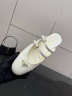 Women's Prada white leather flat with double buckle straps, close side view