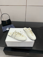 Pair of women's Prada white leather flats with double buckle straps and logo triangle detail