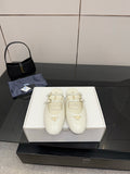 Women's Prada white leather flats with double buckle straps and triangular logo detail