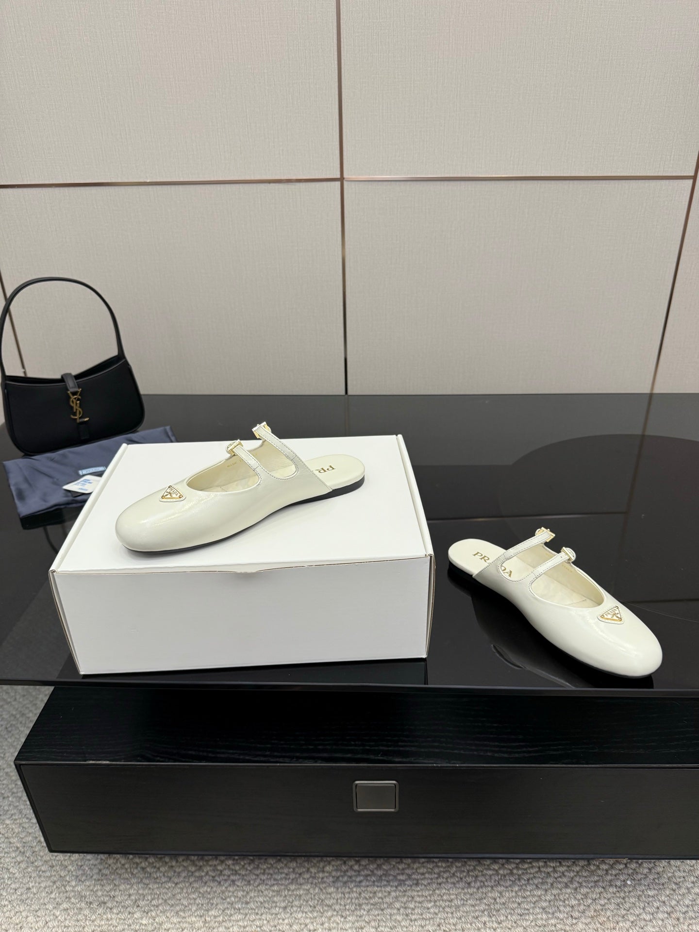 Women's Prada white leather flat with side profile, double buckle strap and logo patch