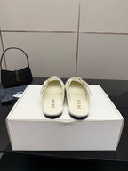 Women's Prada white leather slide flats with double buckle strap, shown on display box