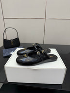 Women's black leather Prada slip-on shoes with front buckle strap