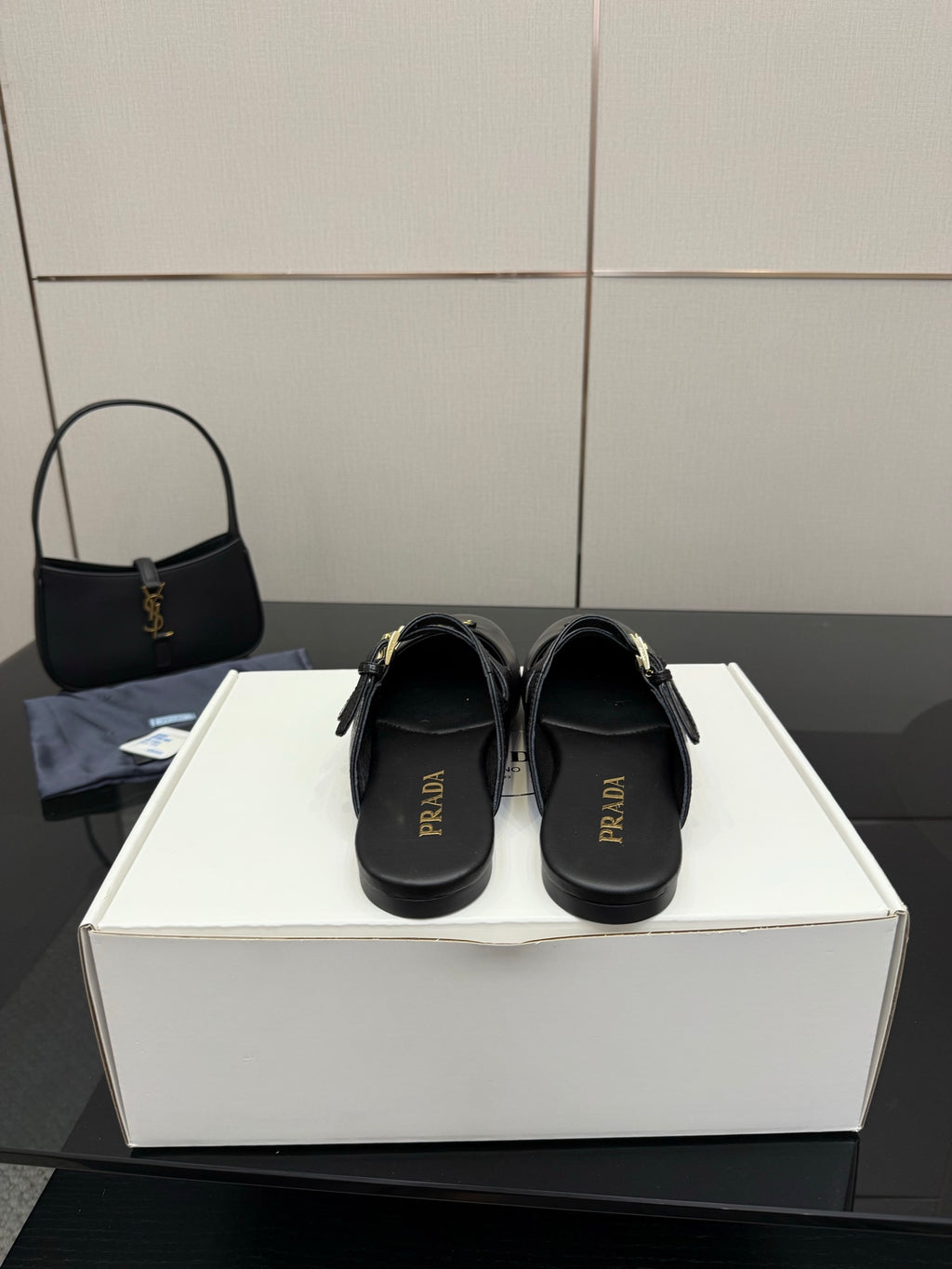 Women's black Prada slip-on shoes with logo on footbed and back strap