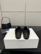 Women's black Prada slip-on shoes with logo on footbed and back strap