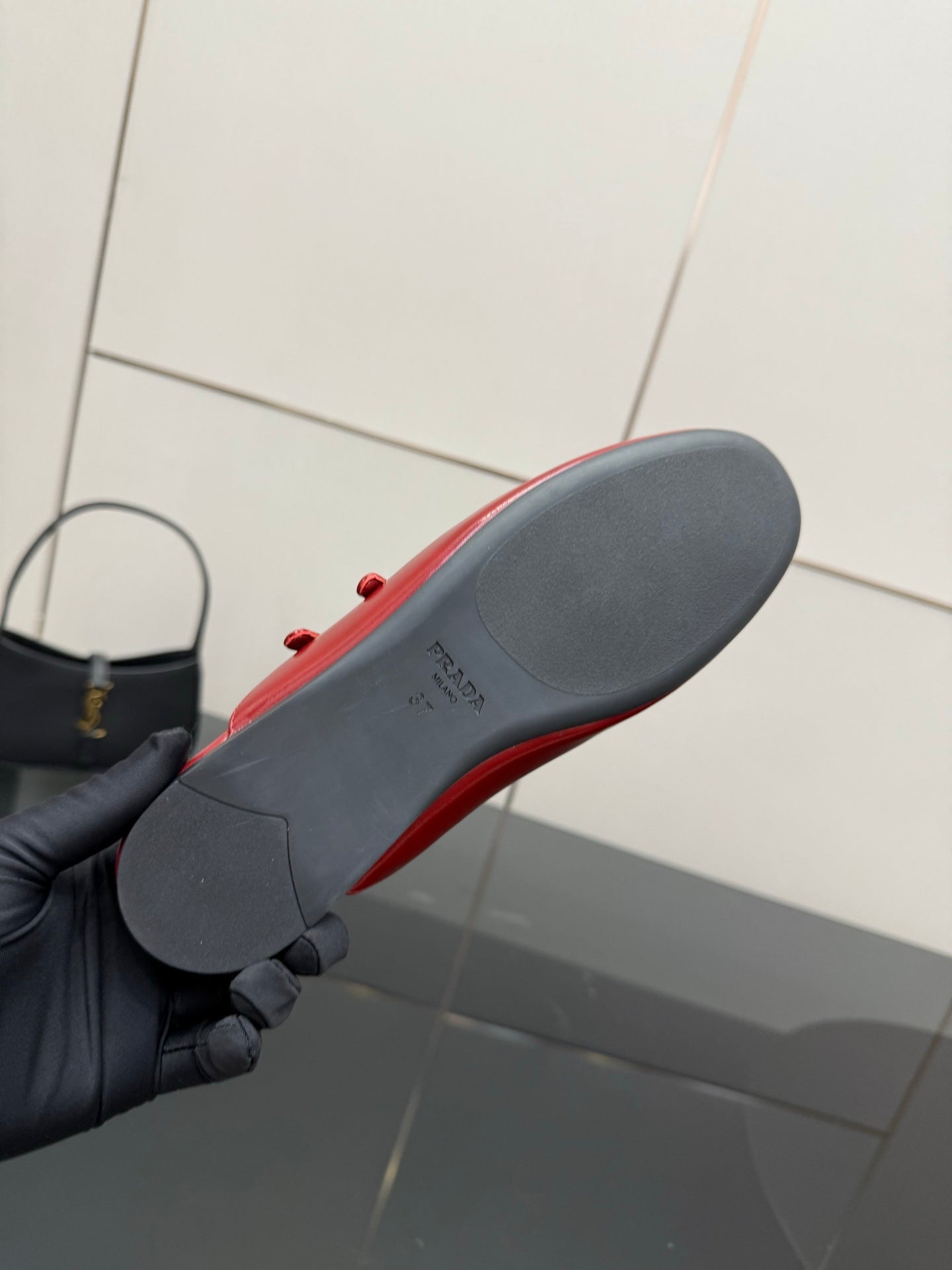 Red leather mule flat with gray outsole, heel underside shown