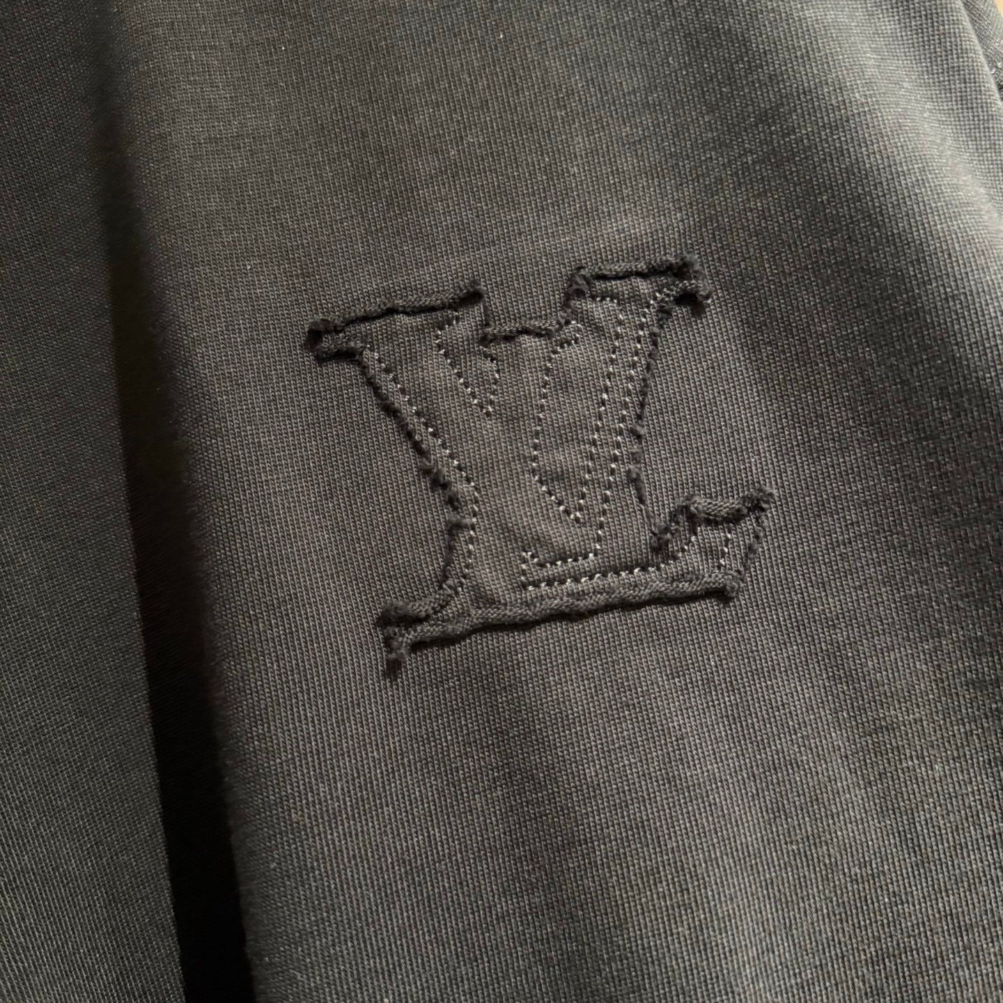 Louis Vuitton dark embroidered LV emblem on black T-shirt fabric
