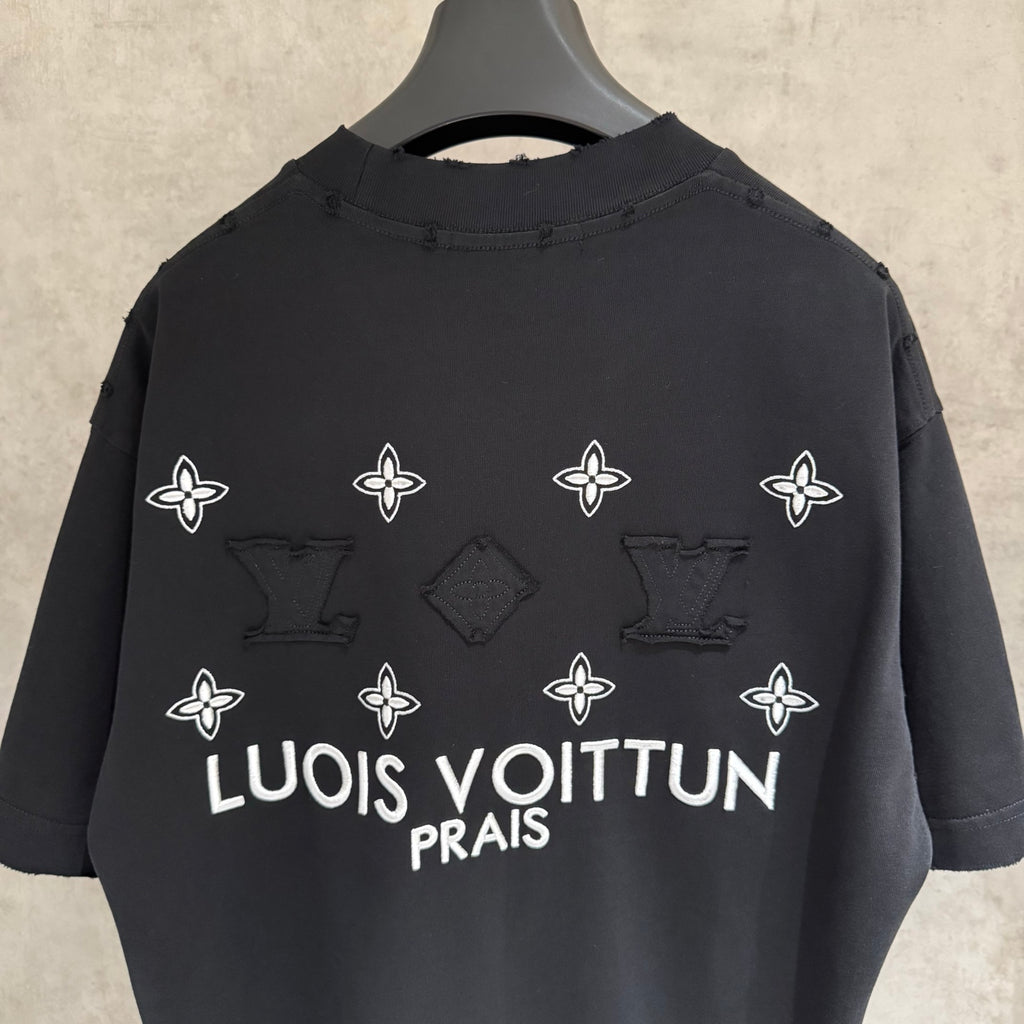 Louis Vuitton black T-shirt with white flower icons and 'LOUIS VUITTON PRAIS' on back
