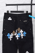 Black cargo pants with large front cross appliques in blue, white, and gold tone