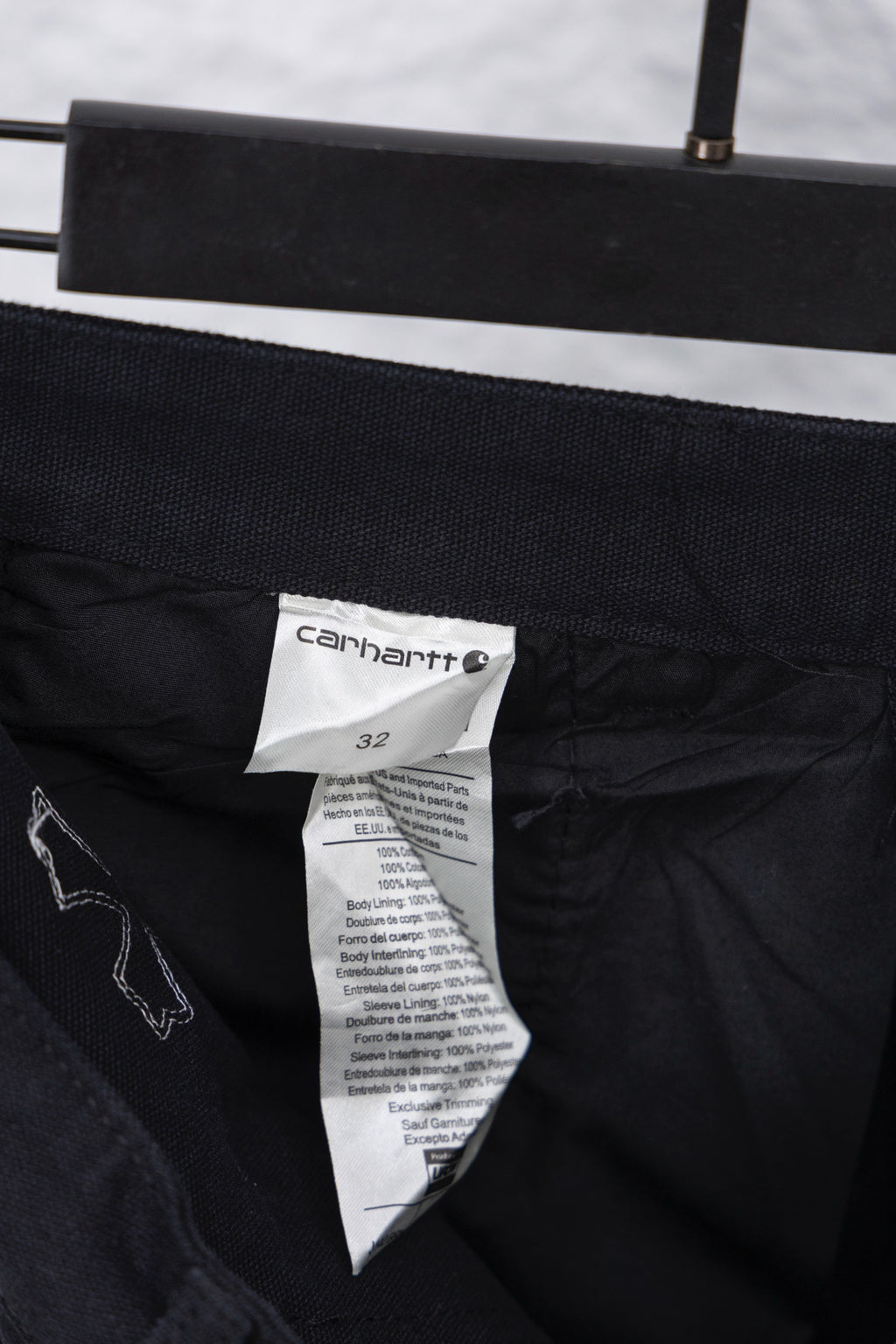 Black inner waistband with size label and care tag on cargo pants