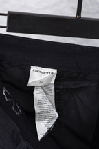 Black inner waistband with size label and care tag on cargo pants