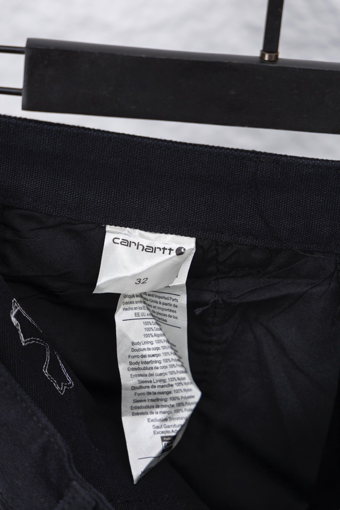 Black inner waistband with size label and care tag on cargo pants