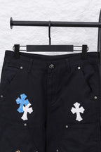 Black cargo pants with cross appliques on front pockets in blue and white