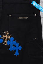 Black cargo pants front close-up with leopard-and-blue cross patch and label