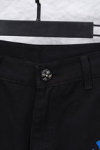 Black pants waistband close-up with decorative snap button