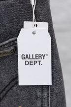 Clothing tag on denim pants reading “GALLERY DEPT.”