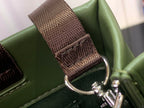 Louis Vuitton tote bag strap detail with brown woven section and metal hardware