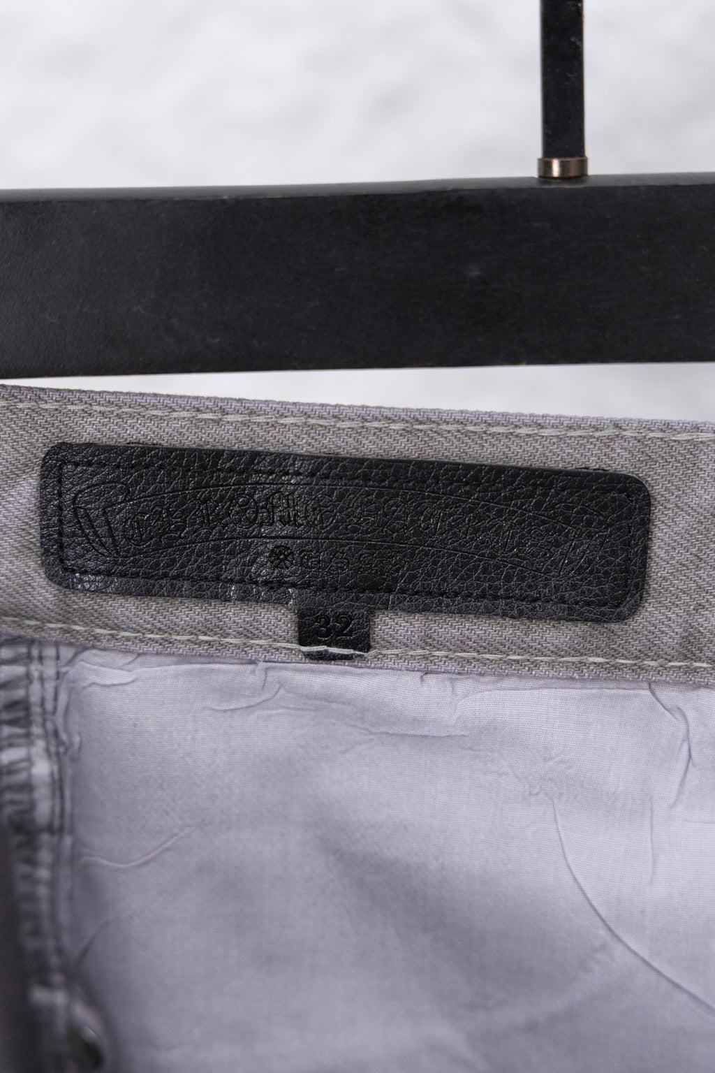 Black fabric label on waistband of Chrome pants