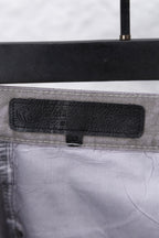 Black fabric label on waistband of Chrome pants