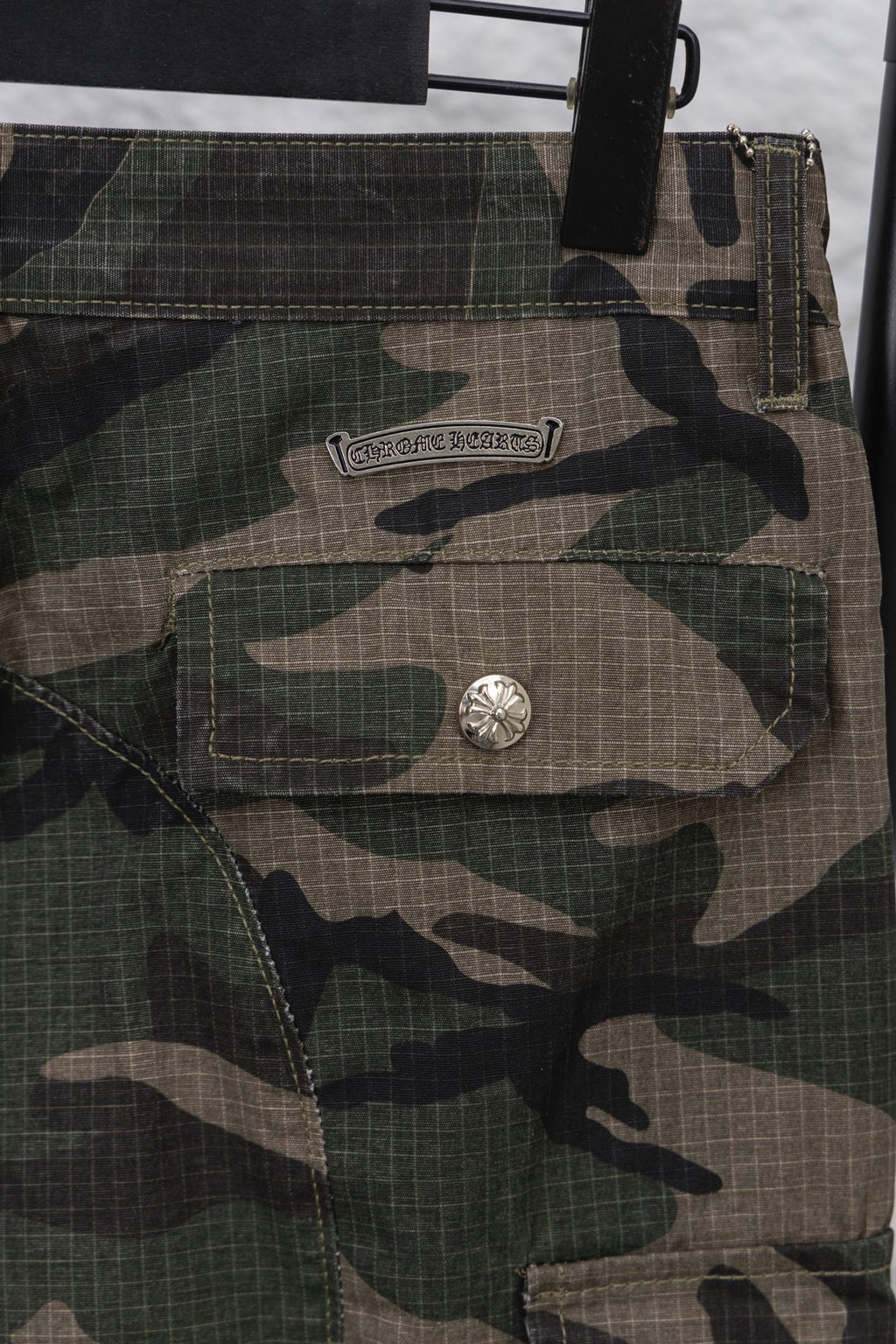 Camouflage pants front pocket and logo patch with metal button detail