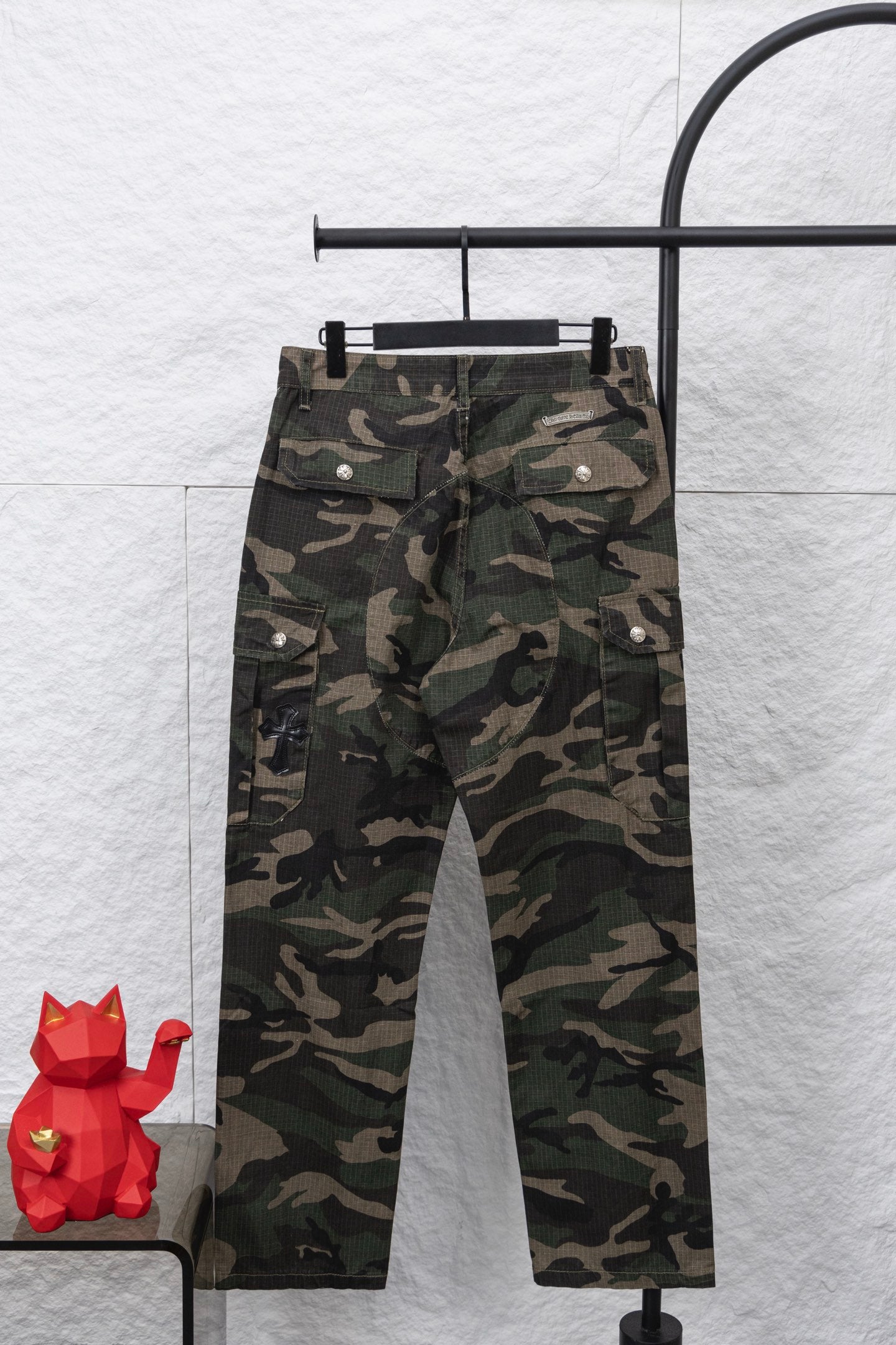 Camouflage pants with button fly and front pockets, full front view