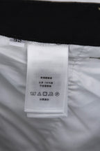 Inner label tag on camouflage pants with care and size information