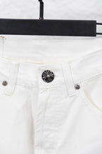White denim pants waistband and button closure with round emblem, close-up