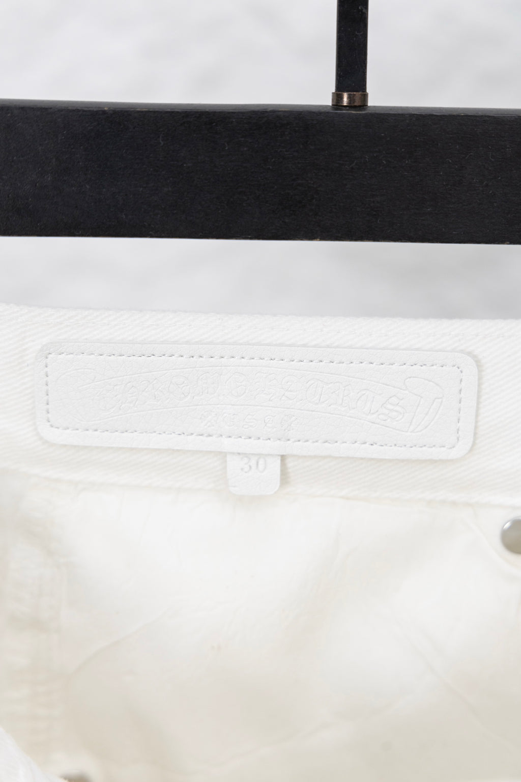 White pants waistband with stitched label patch