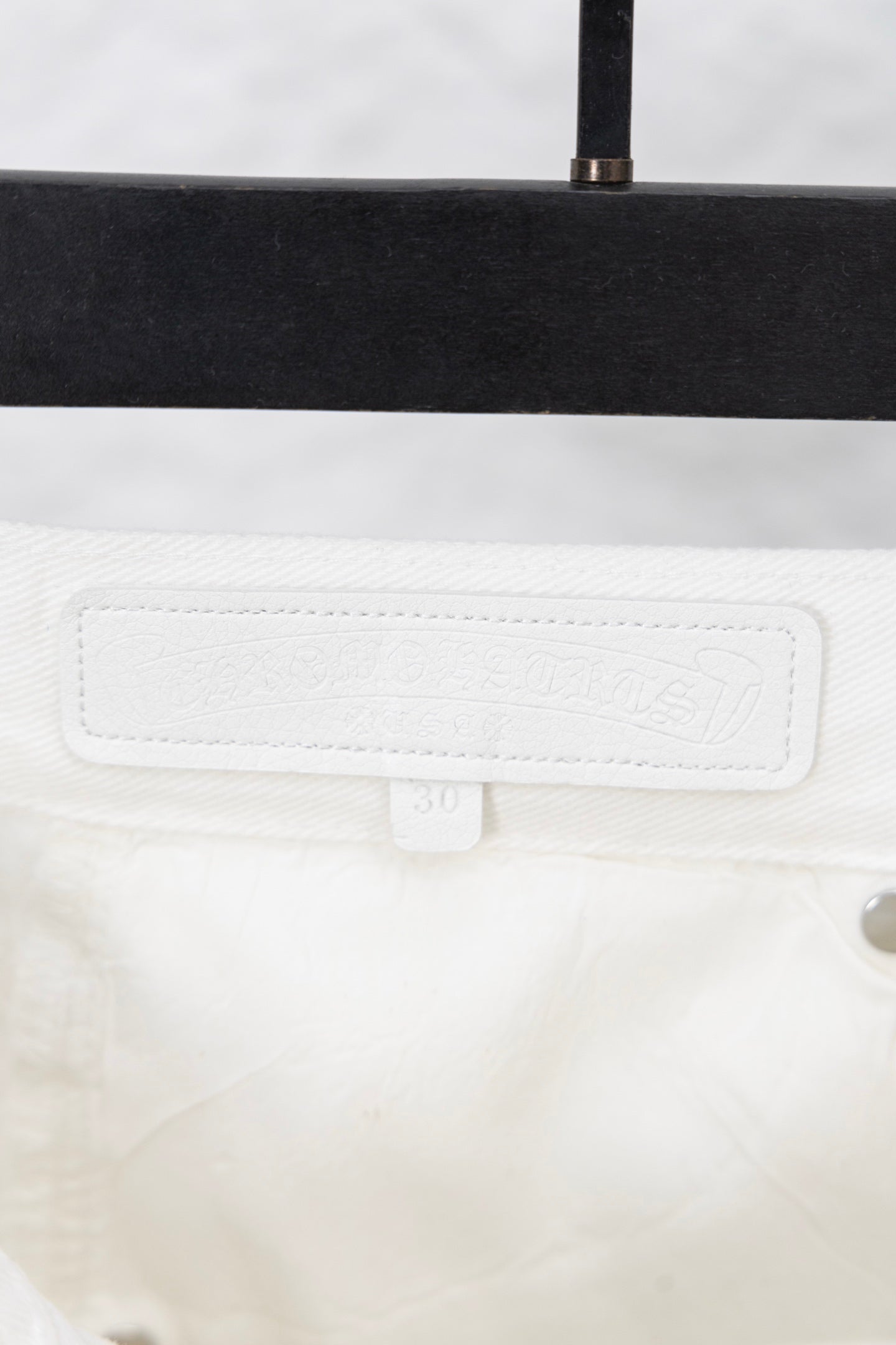 White pants waistband with stitched label patch