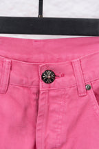 Pink denim pants with front waistband detail and round decorative button