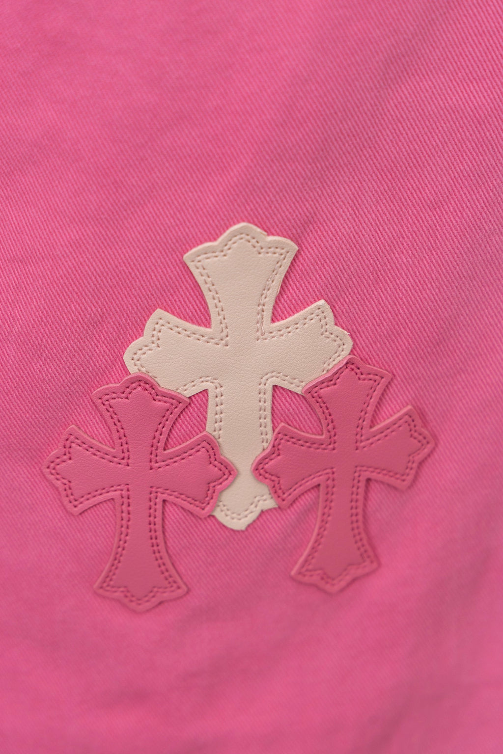 Pink denim fabric with cream cross embroidery appliques