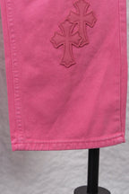 Pink denim pants with cross appliques on the side panel