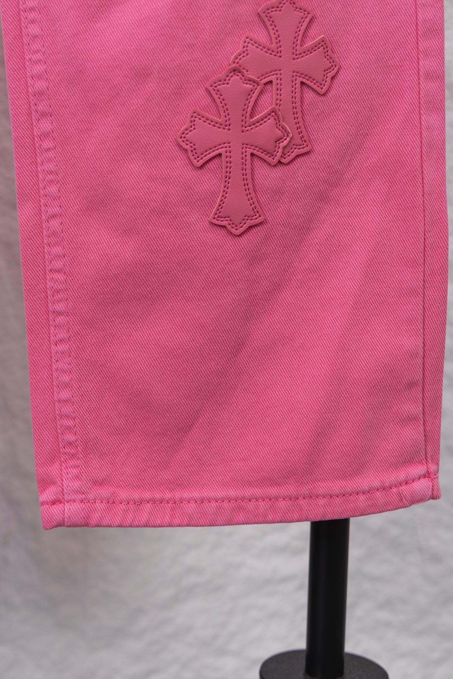 Pink denim pants with cross appliques on the side panel